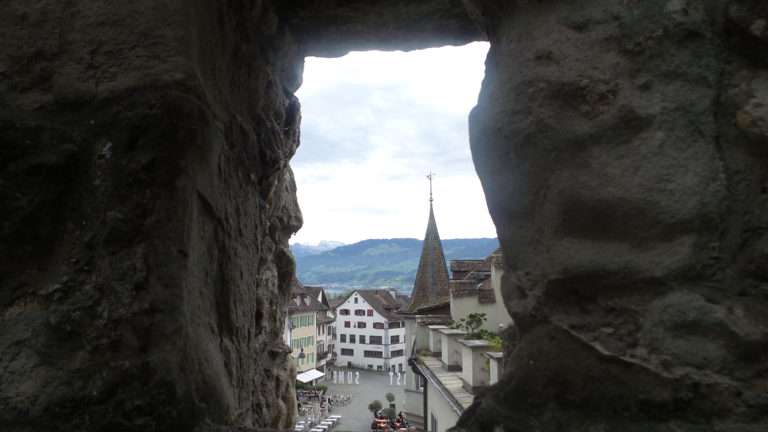 Peeking out the castle - I will eat at the street cafe' below on the right.